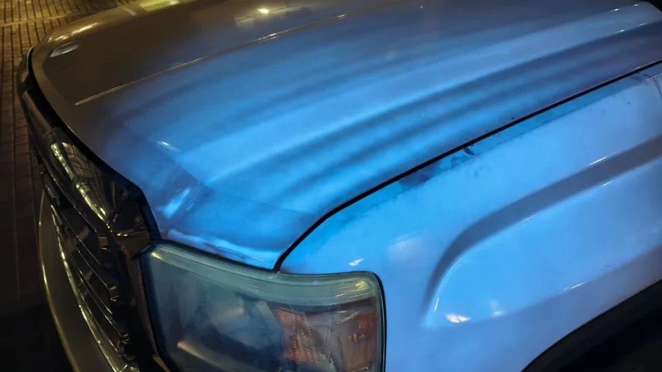 Body-panel examination beneath inspection lighting